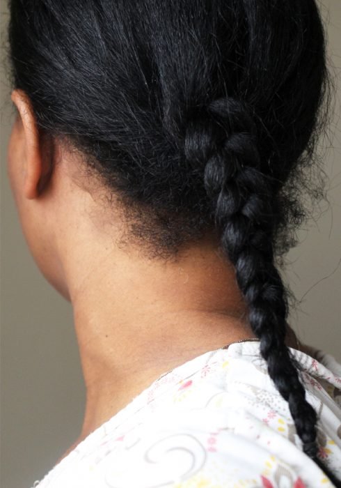 back view of single braid on straight black hair